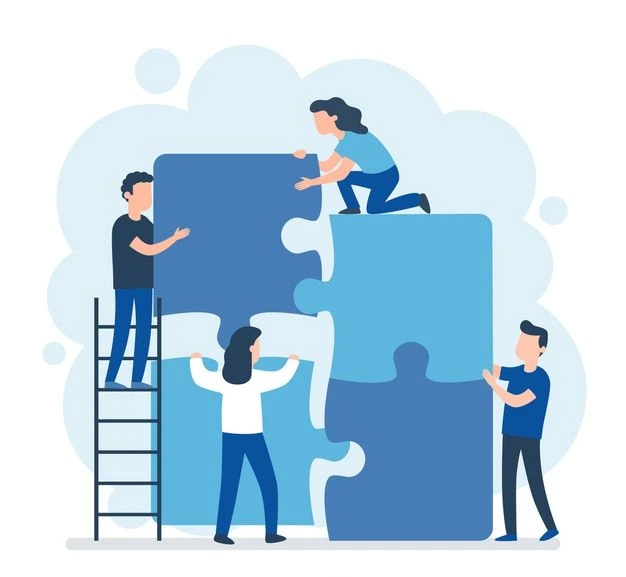 équipe qui se construit avec pièces de puzzle